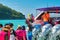 THAILAND, RACHA YAI ISLAND, MARCH 19, 2018 - passengers with children in lifejackets get on the speedboat.