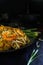 Thailand traditional cuisine, Pad thai, dried noodle, fried noodles, shrimp and seafood, street food, dark food photography