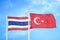 Thailand and Turkey two flags on flagpoles and blue sky