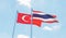 Thailand and Turkey, two flags waving against blue sky