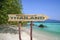 Thailand wooden arrow road sign against beach background. Travel to Thailand concept