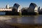 Thames River Flood Barrier, East London, England, UK - 25 February 2018 : View of Barrier Structures with Mudflats in Foreground