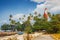 Thangassery Lighthouse on the cliff surrounded by palm trees and big sea waves on the Kollam beach. Kerala, India