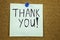 Thank you - colorful sticky notes with handwriting on cork bulletin board.