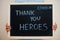 Thank you, heroes. Coronavirus concept. Boy hold inscription on the board