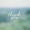 Thank you lettering on blurred nature background