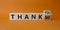 Thank You or Me symbol. Wooden cubes with words Thank Me and thank you. Beautiful orange background. Business and Thanks concept.