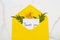 Thank you message card handwriting in envelope and yellow flowers cosmos