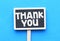 THANK YOU. Mini chalkboard with the word thank you on blue background