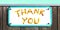 THANK YOU sign of yellow orange flowers collage, enamel, metal or pottery sign, wooden wall. frame, turquoise sky