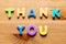 Thank You words written with colorful letters on wooden background