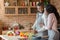 Thankful african lady hugging her husband, cooking together