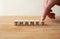 Thanks concept. Word thanks on wooden cube with finger to shows letter s. Wooden table background