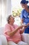 Thanks for making me such a lovely cuppa. a caregiver offering a cup of tea to a senior patient in a nursing home.