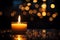 Thanksgiving ambiance Aromatic candle, flame, round bokeh on dark background