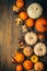 Thanksgiving and autumn background decoration with different pumpkins, dried leaves on wooden background