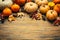 Thanksgiving and autumn background decoration with different pumpkins, dried leaves on wooden background