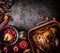 Thanksgiving background. Whole roasted stuffed turkey on dark rustic table with apples, cranberries, various nuts, chestnuts ,