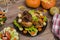 Thanksgiving baked chicken with fresh vegetables and salad. Decoration of pumpkins and autumn leaves