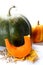 Thanksgiving big and small Pumpkins with slice and seeds on autumn leaves