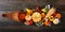 Thanksgiving cornucopia filled with autumn vegetables and pumpkins, above against dark wood