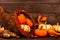 Thanksgiving cornucopia with pumpkins against rustic wood