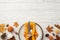 Thanksgiving day concept. Top view photo of plate cutlery fork knife napkin rowan maple leaves pine cones acorns pumpkins and