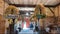 Thanksgiving Day decoration indoors. Ears of grain and braided wreaths hang from the ceiling. Crop gifts such as corn can be seen