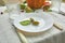 Thanksgiving Day or Halloween dinner table place setting decorative with pumpkin, acorns, pears leaves on white tablecloth backgro