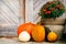 Thanksgiving decorated front door with various size and shape pumpkins and chrysanthemum. Front Porch decorated for the Halloween.