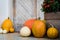 Thanksgiving decorated front door with various size and shape pumpkins and chrysanthemum. Front Porch decorated for Thanksgiving.