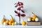 Thanksgiving decoration. Minimal autumn inspired room decoration. Selection of various pumpkins on white shelf.