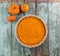 Thanksgiving dessert. Homemade rustic open pumpkin pie with small decorative pumpkins on shabby blue wooden table