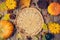 Thanksgiving dinner background with basket. Autumn pumpkin and fall leaves on wooden table