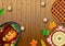 Thanksgiving dinner background with turkey and all sides dishes, pumpkin pie, fall leaves and seasonal autumnal decor on wooden