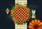 Thanksgiving dinner background with turkey and all sides dishes, pumpkin pie, fall leaves and seasonal autumnal decor on wooden