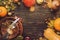 Thanksgiving dinner place setting. Autumn fruit, pumpkins, nuts, fallen leaves with plate and cutlery. Thanksgiving autumn