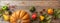 Thanksgiving flat lay with colorful pumpkins, fruits and fall leaves on rustic wooden background, banner