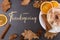 Thanksgiving greetings. Aromatic drink, coffee with marshmallows and spices, leaves on a stone background, top view. Kaligraphic