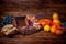 Thanksgiving holiday background with opened chest treasure, apple, pear, tomato, grapes, pot and pumpkins, rural style, close up