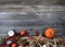 Thanksgiving Pumpkin with acorns and corn on burlap cloth forming border on weathered wooden boards