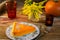 Thanksgiving pumpkin pie slice on the old wooden table