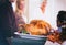 Thanksgiving: Roasted Turkey Rests On Counter While Family Talks
