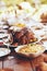 Thanksgiving, table and food with turkey, chicken or poultry for festive holiday meal by blurred background. Fine dining