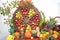 Thanksgiving table with pumpkins, wheel with ripe apples and rose hip twig in a green vase, fruits and vegetables