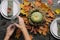 Thanksgiving table setting, hands preparing table for autumnal feast