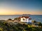 Thasos island at sunrise with blue waters and beautiful small white church greek style