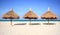 Thatch palapa umbrellas on resort beach