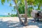 Thatch stilt homes on idyllic tropical beach