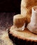 Thatched brown sugar in a cup, wooden background, selective focus